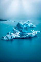 travel in iceland - blue icelandic icebergs in glacier lagoon in fog, beautiful icebergs in polar region 