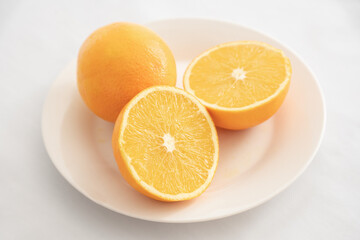 Orange open in half on white plate