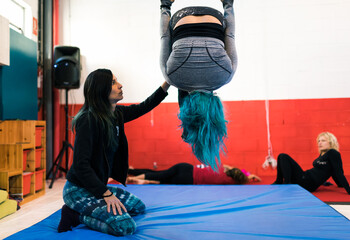 The circus school teacher shows the student an exercise technique
