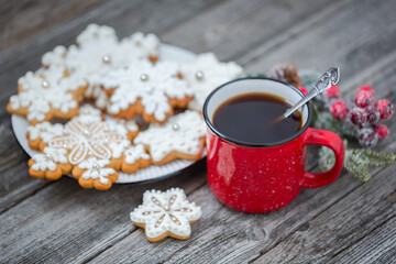 Red cup of coffee with Christmas gingerbread. New Year's still life.