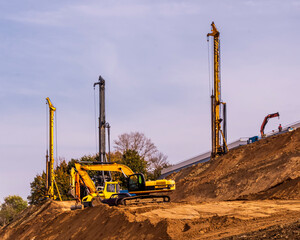 construction machinery and architectural engineering on a construction site, cranes and drilling...