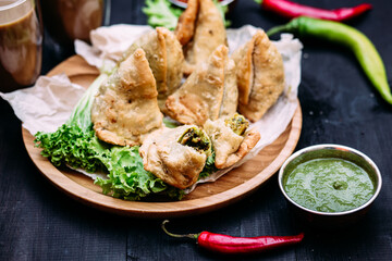 Indian dish samosa on a plate with sauce