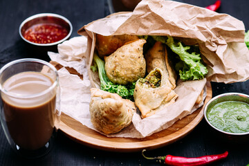 Indian dish samosa on a plate with sauce