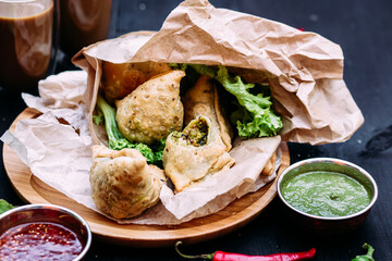 Indian dish samosa on a plate with sauce