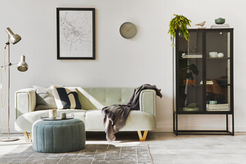 Stylish loft interior with green sofa, design pouf, mock up poster map, furniture, carpet, plants,...