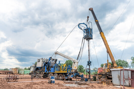 Coiled Tubing Unit Doing Well Clean Out. Wireline Equipment Hanging From Top Drive Ready To Be Lowered Downhole For Logging.