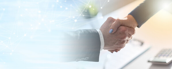 Business agreement with handshake; panoramic banner
