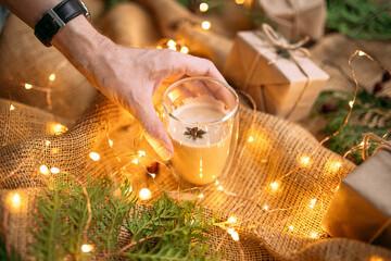 Male hand putting a mug with coffee on sackcloth