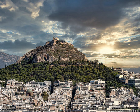 Athens Greece urban area and Lycabettus hill under scenic sky during sunrise