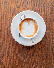 cappuccino coffee cup top vew closeup on wooden table, space for your text