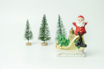 Santa sat on ice skates in front of Christmas tree waiting for the festival of happiness