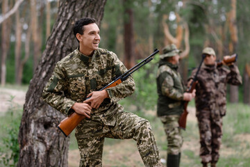 Proud Hunter Happy Team of Men in Summer Forest.