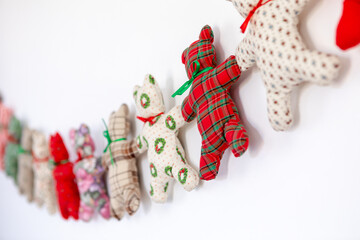 Angled View of Homemade Minimalist Holiday Decoration of Simple Teddy Bears Sewn By Hand in Christmas Pattern Fabrics