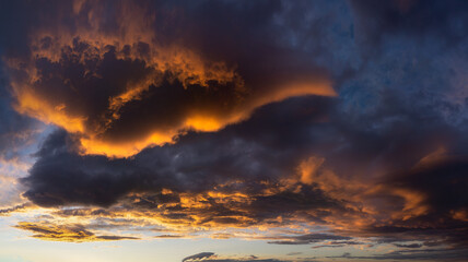 Fototapeta premium beautiful dark cloudscape at sunset with red clouds
