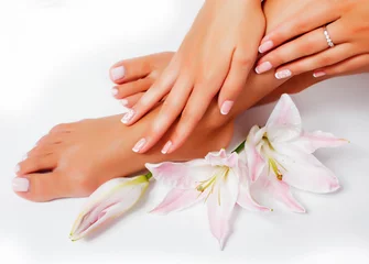 Poster manicure pedicure with flower lily closeup isolated on white perfect shape hands spa salon © iordani
