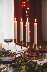 Christmas Eve table with candles and decorations.