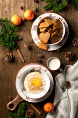 Christmas rice pudding with cinnamon and butter in the bowls with Norwegian julenisser.  Traditional Norwegian Christmas dessert and breakfast