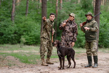 Group of Hunters Pointing to Direction in Forest.
