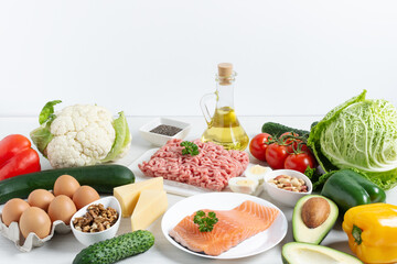 Ingredients for ketogenic diet on white wooden table.
