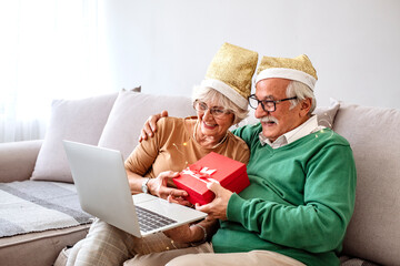 Аn elderly family talking to their children and grandchildren and keeping a distance, during COVID-19. Senior couple at home having a celebration on a video call