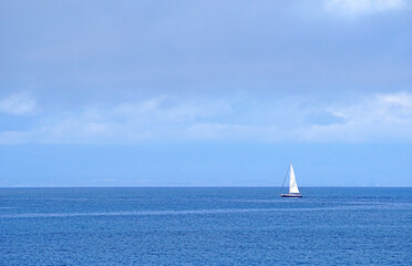 Seascape and Tranquil scene of white  sailboat on the ocean with blue ocean and cloud blue sky  -...