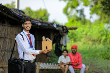 Young indian banker or agronomist visit poor farmer family