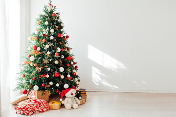 Christmas tree by the window interior of the room New Year holiday gifts