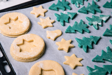 Homemade Christmas cookies before baking on a baking sheet, close-up. Horizontal orientation
