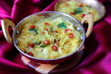 Poha Chivda or Chiwada. Diwali special savory snack, made out of Flattened rice, fried peanuts, curry leaves and some spices. Traditional Indian Diwali Snacks.  with Copy Space.