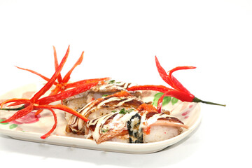 Healthy Home Cooking - Grilled pork sushi placed on a white plate, is a Japanese style Thai food on a white background and is sold at Thailand and every festival.