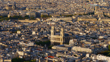 Obraz premium Aerial panorama view of historic city center of Paris, France with popular cathedral Saint-Sulpice (Roman Catholic church) and Centre Pompidou in background in the beautiful evening sun in autumn.