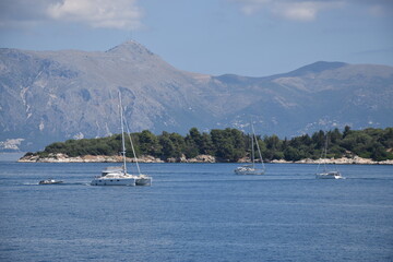 Boats on the sea next to the small island