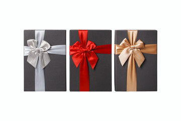 Three gift boxes with red silver and gold ribbons on a white background..
