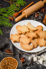 Christmas homemade gingerbread cookies on a white table top view.   Festive homemade gingerbread cookies. Christmas time. Traditional Christmas cookies
