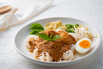 Rice noodles in fish curry sauce with meatball and vegetable (Kanom Jeen Nam Ya)