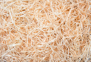 Top view of natural color shredded wood excelsior for filling inside box when sending package....
