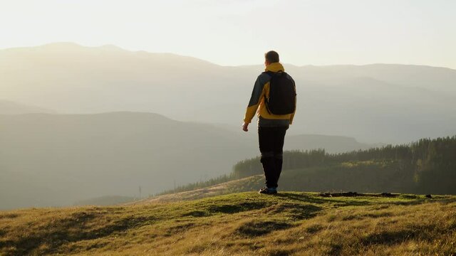 A man travels in the mountains. Beautiful nature of the Carpathian mountains. The concept of travel and active lifestyle. 4K