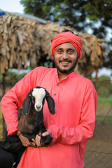 Indian farmer in goat dairy farm