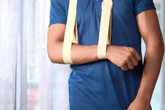 young man wearing an arm brace for broken hand .