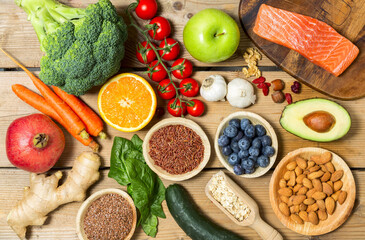  Healthy food, clean eating selection: fruit, vegetable, seeds, superfood, cereals, leaf vegetable on wooden background copy space.
