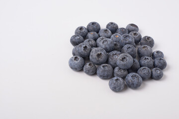 Berry background. Fresh berry blueberries on a white background. Concept of healthy and diet food. Flat lay, top view, Ripe blueberries with copy space for text, shallow DOF
