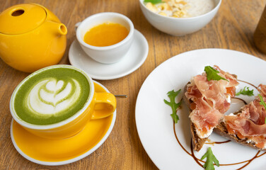 Nice Breakfast, toast with soft cheese and prosciutto. Matcha latte tea. Beautiful serving of bruschetta. Light lunch with coffee