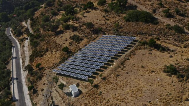 Aerial Shot of Rows of Solar Panels by the Mountains in Crete, Greece