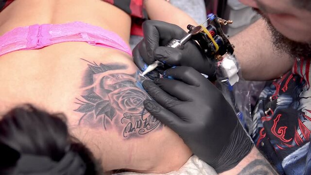 Professional tattooer doing tattoo picture in studio