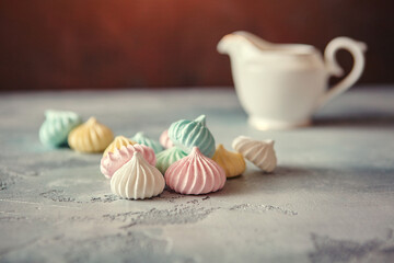 Meringues of a delicate pastel color are on the table for morning tea