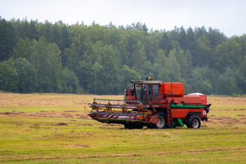 Fototapeta na wymiar Heavy duty farm equipment in the field. Big combine harvester vehicle outside