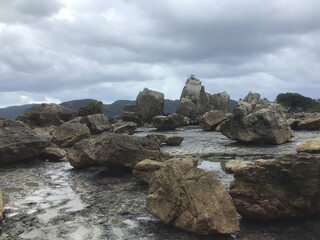 Fototapeta na wymiar A group of huge rocks extending straight to Oshima called Hashiguiiwa