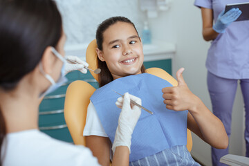 Fast and painless dental treatment in modern clinic with medical team