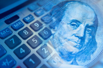 Podschet money. Calculator keys next to franklin portrait. Concept - accounting services. Fragment of a calculator close-up. Concept - personal finance. Financial analysis. Analysis personal expenses