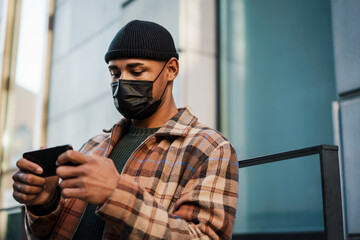 Young african man wearing safety mask